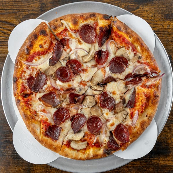 Oak Pantry Deli n' Pizza's pepperoni, mushroom, and red onion pizza on a metal tray.