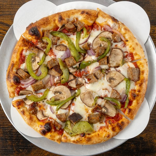 Oak Pantry Deli n' Pizza's sausage, mushroom, green pepper, and red onion pizza on a metal tray.