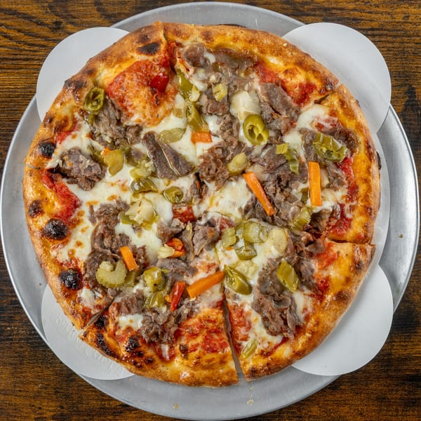 Oak Pantry Deli n' Pizza's beef and giardiniera pizza on a metal tray.